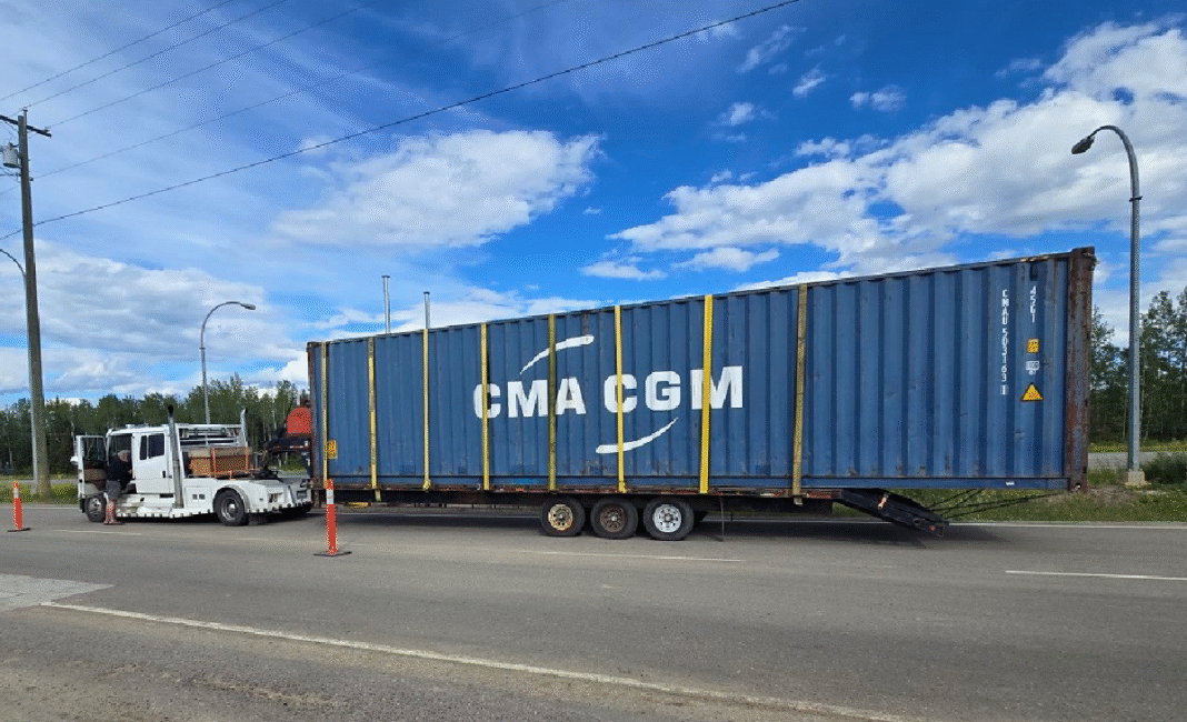 Overloaded transport trailer towed in Fort Nelson by BC Highway Patrol