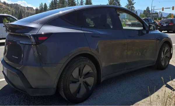 West Kelowna tesla driver ticketed after reading documents while driving on Highway 97 
