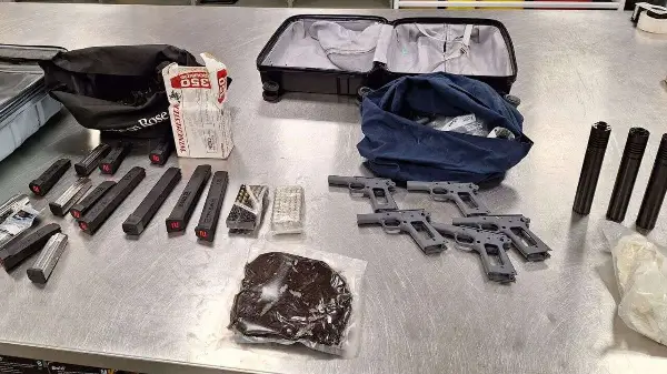 Man charged after loaded handguns seized from stolen truck